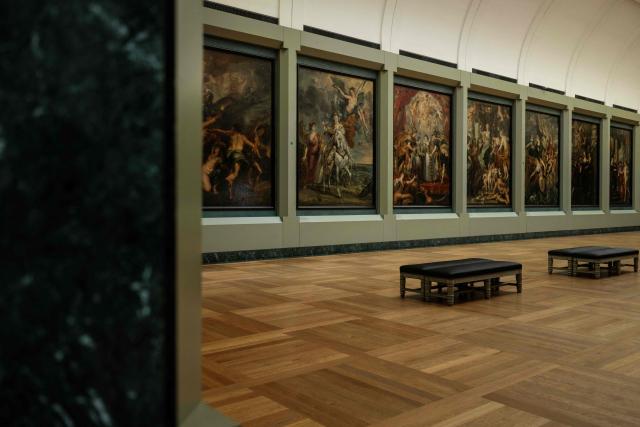 This photograph shows a general view of The Medicis Gallery, in which are displayed 24 paintings by Flemish artist Peter Paul Rubens constituting the 'Marie de Medici Cycle', before their restoration, at Musee du Louvre in Paris on March 24, 2026. The Louvre has unveiled the details of an “exceptional operation” to restore the 24 paintings of the “Marie de’ Medici Cycle,” painted in the early 17th century by Rubens, one of the masters of Flemish painting. A call for tenders is underway to find two teams of restorers who will work simultaneously, starting in the autumn, on a project expected to last four years. (Photo by Blanca CRUZ / AFP)