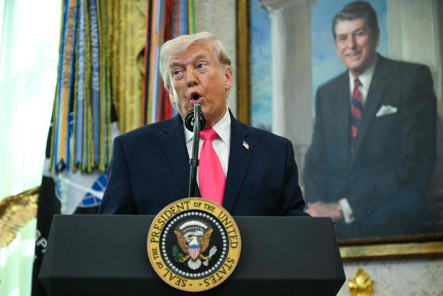 US President Donald Trump speaks before swearing in the new Secretary of Homeland Security Markwayne Mullin in the Oval Office of the White House in Washington, DC, on March 24, 2026. The US Senate on Monday confirmed Mullin as the new chief of the Department of Homeland Security (DHS), the agency reeling from a partial government shutdown as it works to enforce President Donald Trump's immigration crackdown. (Photo by Jim WATSON / AFP)