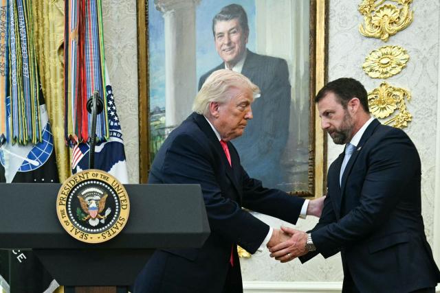 US President Donald Trump shakes hands with the newly sworn in Secretary of Homeland Security Markwayne Mullin in the Oval Office of the White House in Washington, DC, on March 24, 2026. The US Senate on Monday confirmed Mullin as the new chief of the Department of Homeland Security (DHS), the agency reeling from a partial government shutdown as it works to enforce President Donald Trump's immigration crackdown. (Photo by Jim WATSON / AFP)