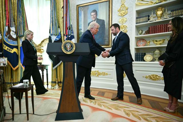 US President Donald Trump shakes hands with the newly sworn in Secretary of Homeland Security Markwayne Mullin in the Oval Office of the White House in Washington, DC, on March 24, 2026. The US Senate on Monday confirmed Mullin as the new chief of the Department of Homeland Security (DHS), the agency reeling from a partial government shutdown as it works to enforce President Donald Trump's immigration crackdown. (Photo by Jim WATSON / AFP)