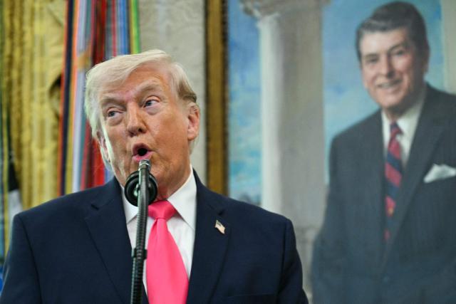 US President Donald Trump speaks before swearing in the new Secretary of Homeland Security Markwayne Mullin in the Oval Office of the White House in Washington, DC, on March 24, 2026. The US Senate on Monday confirmed Mullin as the new chief of the Department of Homeland Security (DHS), the agency reeling from a partial government shutdown as it works to enforce President Donald Trump's immigration crackdown. (Photo by Jim WATSON / AFP) / ALTERNATE CROP
