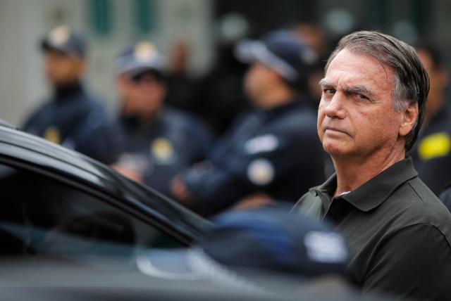 (FILES) Former Brazilian President (2019-2022) Jair Bolsonaro leaves the DF Star hospital in Brasilia on September 14, 2025, after undergoing a series of medical examinations, as he remains under house arrest. A Brazilian Supreme Court judge authorized on March 24, 2026, former President Jair Bolsonaro to serve his sentence under “humanitarian” house arrest as soon as he is discharged from the hospital, where he has been admitted for 11 days for pneumonia. (Photo by Sergio Lima / AFP)
