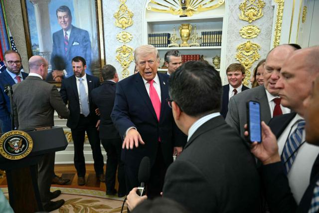 US President Donald Trump speaks with reporters at the conclusion of a swearing in ceremony for the new Secretary of Homeland Security Markwayne Mullin in the Oval Office of the White House in Washington, DC, on March 24, 2026. The US Senate on Monday confirmed Mullin as the new chief of the Department of Homeland Security (DHS), the agency reeling from a partial government shutdown as it works to enforce President Donald Trump's immigration crackdown. (Photo by Jim WATSON / AFP)