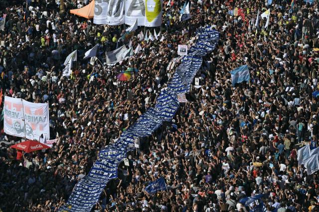 Aerial view of demonstrators holding portraits of disappeared people during a march to Mayo Square on the 50th anniversary of the beginning of the last military dictatorship (1976-1983) in Buenos Aires on March 24, 2026. In Argentina, March 24th is a day of mourning, marches and political disputes. Fifty years on from the coup d’etat, thousands of people are taking to the streets again to commemorate the victims of a dictatorship that the government of far-right leader Javier Milei is seeking to rewrite. (Photo by Juan Mabromata / AFP)