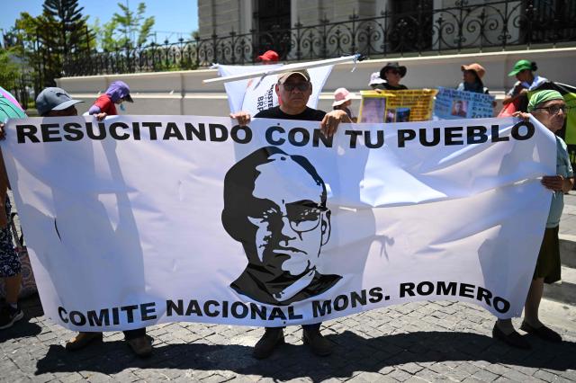 People protest against the emergency regime imposed by El Salvador's President Nayib Bukele's government since March 2022 during a march to commemorate the 46th anniversary of the assassination of Salvadoran Archbishop Oscar Arnulfo Romero (1917–1980) in San Salvador on March 24, 2026. (Photo by Marvin RECINOS / AFP)