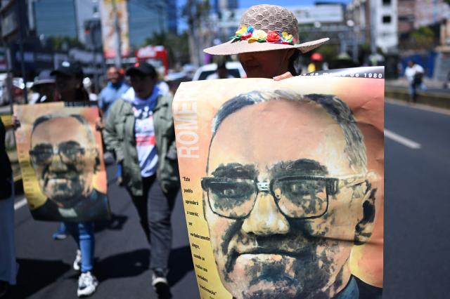 People protest against the emergency regime imposed by El Salvador's President Nayib Bukele's government since March 2022 during a march to commemorate the 46th anniversary of the assassination of Salvadoran Archbishop Oscar Arnulfo Romero (1917–1980) in San Salvador on March 24, 2026. (Photo by Marvin RECINOS / AFP)