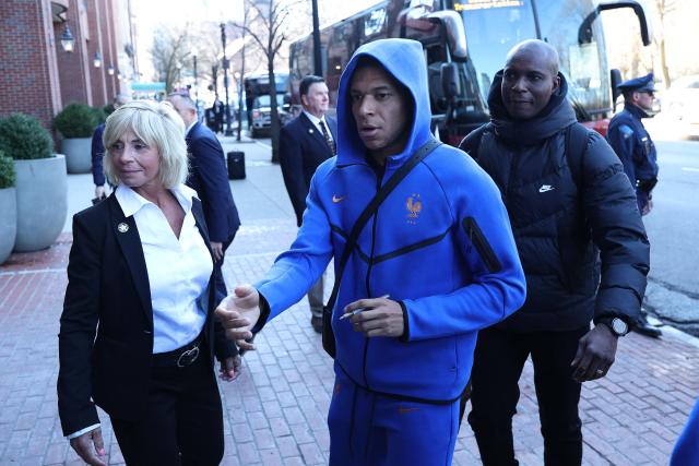 France's forward Kylian Mbappe signs autographs upon arriving at the hotel in Boston on March 24, 2026. France will play two friendly matches against Brazil on March 26 in Boston and against Colombia on March 29 in Landover. (Photo by FRANCK FIFE / AFP)