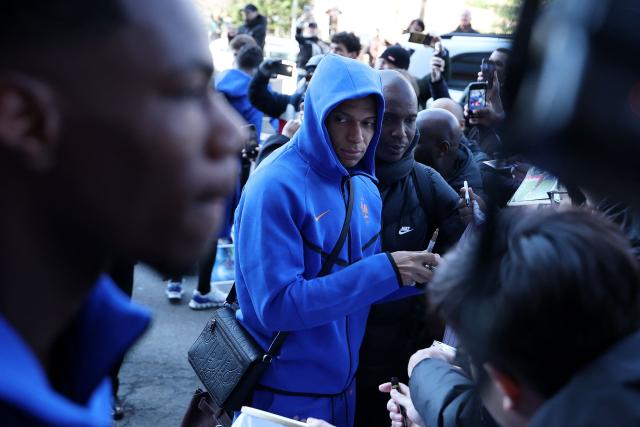 France's forward Kylian Mbappe signs autographs upon arriving at the hotel in Boston on March 24, 2026. France will play two friendly matches against Brazil on March 26 in Boston and against Colombia on March 29 in Landover. (Photo by FRANCK FIFE / AFP)