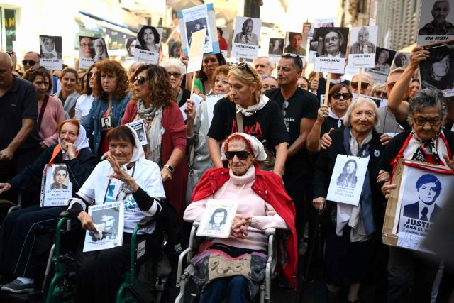 Clara Weinstein (L), Lidia Estela Mercedes Miy Uranga, known as Taty Almeida (2nd-L), and Elia Espen (3rd-L), members of the Argentine human rights group "Madres de Plaza de Mayo," attend a demonstration at Mayo Square on the 50th anniversary of the beginning of the last military dictatorship (1976-1983) in Buenos Aires on March 24, 2026. In Argentina, March 24th is a day of mourning, marches and political disputes. Fifty years on from the coup detat, thousands of people are taking to the streets again to commemorate the victims of a dictatorship that the government of far-right leader Javier Milei is seeking to rewrite. (Photo by Luis ROBAYO / AFP)