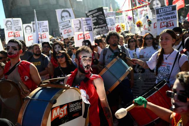 People take part in a march to Plaza de Mayo aquare in Buenos Aires on March 24, 2026, on the 50th anniversary of the beginning of the last military dictatorship. In Argentina, March 24th is a day of mourning, marches and political disputes. Fifty years on from the coup d’etat, thousands of people are taking to the streets again to commemorate the victims of a dictatorship that the government of far-right leader Javier Milei is seeking to rewrite. (Photo by Luis ROBAYO / AFP)