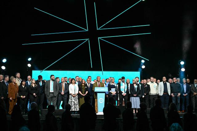 Reform UK party leader Nigel Farage (C) joins candidates during a local election campaign rally in Leeds, northern England on March 24, 2026. (Photo by Oli SCARFF / AFP)