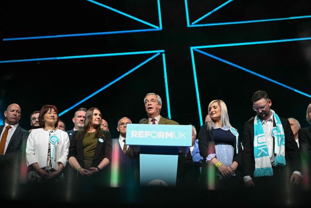 Reform UK party leader Nigel Farage (C) joins candidates during a local election campaign rally in Leeds, northern England on March 24, 2026. (Photo by Oli SCARFF / AFP)