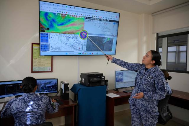 Mexican Air Force lieutenant and meteorologist Jennifer Velazquez explains to AFP how the meteorological service operates for Mexican Air Force squadrons at the Santa Lucia Military Base in Zumpango, State of Mexico, on March 24, 2026. (Photo by Alfredo ESTRELLA / AFP)