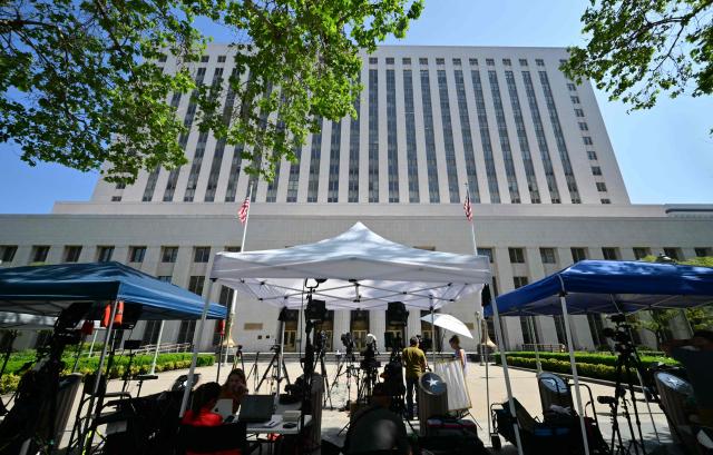 Members of the media wait outside the Los Angeles Superior Court in Los Angeles, on March 24, 2026 as the jury continues deliberations in a trial over whether social media platforms were designed to be addictive to children. Jurors resume deliberations on March 24 in a landmark social media trial after signaling that they were having trouble agreeing when it comes to one of the two defendants, Meta and YouTube. "The jury has difficulty coming to a consensus regarding one defendant, do you have any advice on how to move forward?" the jurors told Judge Carolyn Kuhl, according to a note she read out loud. Kuhl responded by asking the jurors to continue their deliberations."If you are unable to reach a verdict, the case will have to be applied before another jury selected in the same manner and from the same community from which you were chosen, and add additional cost to everyone," she told the jurors. (Photo by Frederic J. Brown / AFP)