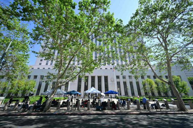 Members of the media wait outside the Los Angeles Superior Court in Los Angeles, on March 24, 2026 as the jury continues deliberations in a trial over whether social media platforms were designed to be addictive to children. Jurors resume deliberations on March 24 in a landmark social media trial after signaling that they were having trouble agreeing when it comes to one of the two defendants, Meta and YouTube. "The jury has difficulty coming to a consensus regarding one defendant, do you have any advice on how to move forward?" the jurors told Judge Carolyn Kuhl, according to a note she read out loud. Kuhl responded by asking the jurors to continue their deliberations."If you are unable to reach a verdict, the case will have to be applied before another jury selected in the same manner and from the same community from which you were chosen, and add additional cost to everyone," she told the jurors. (Photo by Frederic J. Brown / AFP)