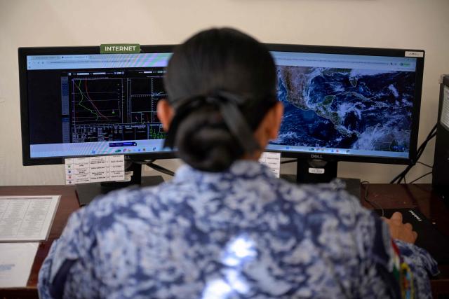 A member of the Mexican Air Force checks the monitors at the meteorological service for Mexican Air Force squadrons at the Santa Lucia Military Base in Zumpango, State of Mexico, on March 24, 2026. (Photo by Alfredo ESTRELLA / AFP)