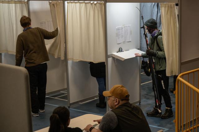A resident enters a voting booth with her skis to vote in the parliamentary election in Denmark in Nuuk, Greenland, on March 24, 2026. (Photo by Florent VERGNES / AFP)