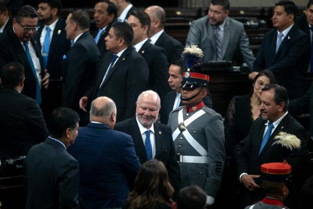 Guatemalan magistrate Roberto Molina Barreto (C) greets congressional deputies before being sworn in at the Constitutional Court in Guatemala City on March 24, 2026. (Photo by Edwin BERCIAN / AFP)