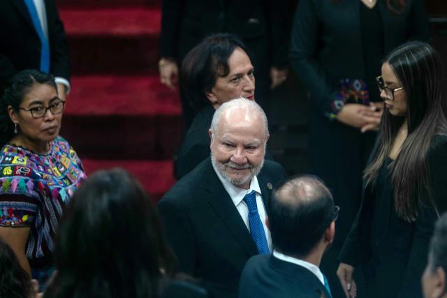 Guatemalan magistrate Roberto Molina Barreto (C) greets congressional deputies before his swearing-in at the Constitutional Court in Guatemala City on March 24, 2026. (Photo by Edwin BERCIAN / AFP)