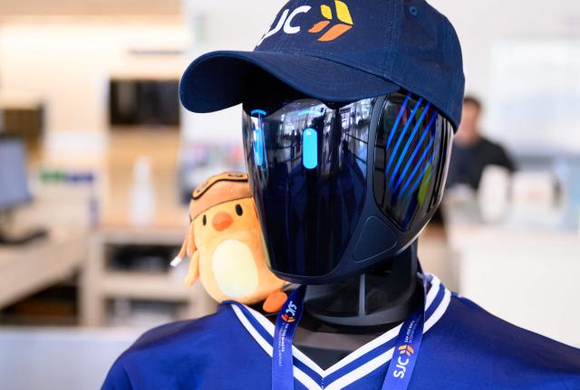 Ernie plush toy sits on the shoulder of AI-powered robot named Jose that greets travelers, answers questions and provides real-time information is displayed during a media event at San Jose Mineta International Airport in San Jose, California, on March 24, 2026. Developed by local AI startup IntBot, the robot is part of a four-month engagement with SJC and will be stationed in Terminal B, Gate 24. Jose is designed to greet travellers and answer questions while providing real-time information in over 50 languages. (Photo by JOSH EDELSON / AFP)