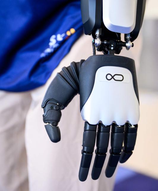 An AI-powered robot named Jose (detail hands) that greets travelers, answers questions and provides real-time information is displayed during a media event at San Jose Mineta International Airport in San Jose, California, on March 24, 2026. Developed by local AI startup IntBot, the robot is part of a four-month engagement with SJC and will be stationed in Terminal B, Gate 24. Jose is designed to greet travellers and answer questions while providing real-time information in over 50 languages. (Photo by JOSH EDELSON / AFP)