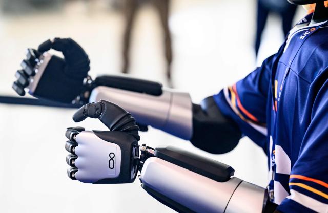 An AI-powered robot named Jose (detail hands) that greets travelers, answers questions and provides real-time information is displayed during a media event at San Jose Mineta International Airport in San Jose, California, on March 24, 2026. Developed by local AI startup IntBot, the robot is part of a four-month engagement with SJC and will be stationed in Terminal B, Gate 24. Jose is designed to greet travellers and answer questions while providing real-time information in over 50 languages. (Photo by JOSH EDELSON / AFP)