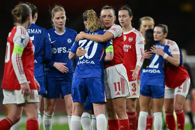Arsenal's Irish striker #11 Katie McCabe (centre R) embraces Chelsea's English midfielder #30 Keira Walsh (centre L) at the end of the UEFA Women's Champions League quarter-final 1st leg football match between Arsenal and Chelsea at The Emirates Stadium in London on March 24, 2026. (Photo by Glyn KIRK / AFP)