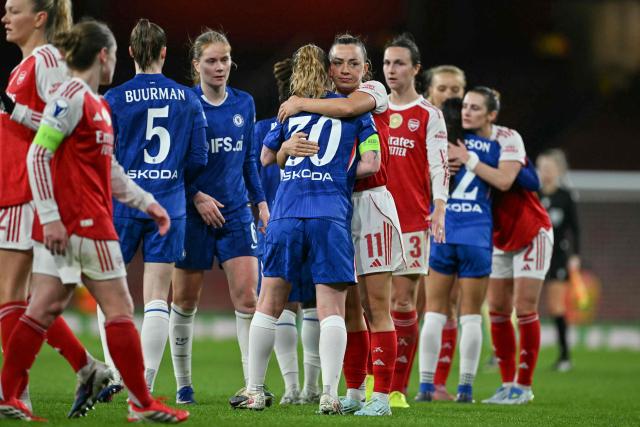 Arsenal's Irish striker #11 Katie McCabe (centre R) embraces Chelsea's English midfielder #30 Keira Walsh (centre L) at the end of the UEFA Women's Champions League quarter-final 1st leg football match between Arsenal and Chelsea at The Emirates Stadium in London on March 24, 2026. (Photo by Glyn KIRK / AFP)
