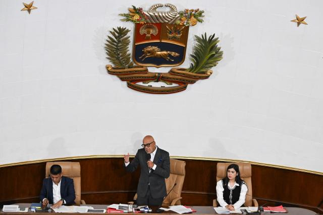 Venezuela's National Assembly President Jorge Rodriguez (C) speaks next to First Vice President Pedro Infante (L), and Second Vice President America Perez during a session at the National Assembly in Caracas on March 24, 2026. (Photo by Juan BARRETO / AFP)