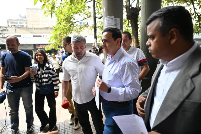 Venezuelan political activist Javier Tarazona (C) walks outside the Justice Palace in Caracas on March 24, 2026. A Venezuelan court refused to grant an amnesty to renowned activist Javier Tarazona on March 24, 2026, who was released on parole on February 1 after four years incarcerated for "terrorism" and "treason." (Photo by Juan BARRETO / AFP)