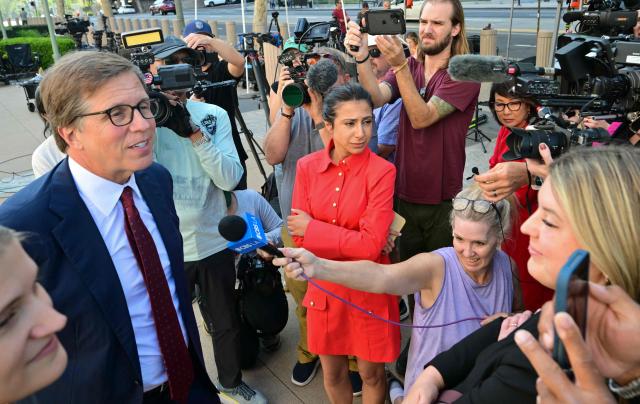 Plaintiffs' attorney Mark Lanier (L) speaks to journalists outside the Los Angeles Superior Court courthouse as the jury continues deliberations in a trial on whether social media platforms were designed to be addictive to children, in Los Angeles on March 24, 2026. Jurors resume deliberations on March 24 in a landmark social media trial after signaling that they were having trouble agreeing when it comes to one of the two defendants, Meta and YouTube. "The jury has difficulty coming to a consensus regarding one defendant, do you have any advice on how to move forward?" the jurors told Judge Carolyn Kuhl, according to a note she read out loud. Kuhl responded by asking the jurors to continue their deliberations."If you are unable to reach a verdict, the case will have to be applied before another jury selected in the same manner and from the same community from which you were chosen, and add additional cost to everyone," she told the jurors. (Photo by Frederic J. Brown / AFP)