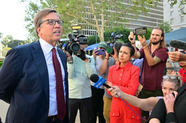 Plaintiffs' attorney Mark Lanier (L) speaks to journalists outside the Los Angeles Superior Court courthouse as the jury continues deliberations in a trial on whether social media platforms were designed to be addictive to children, in Los Angeles on March 24, 2026. Jurors resume deliberations on March 24 in a landmark social media trial after signaling that they were having trouble agreeing when it comes to one of the two defendants, Meta and YouTube. "The jury has difficulty coming to a consensus regarding one defendant, do you have any advice on how to move forward?" the jurors told Judge Carolyn Kuhl, according to a note she read out loud. Kuhl responded by asking the jurors to continue their deliberations."If you are unable to reach a verdict, the case will have to be applied before another jury selected in the same manner and from the same community from which you were chosen, and add additional cost to everyone," she told the jurors. (Photo by Frederic J. Brown / AFP)