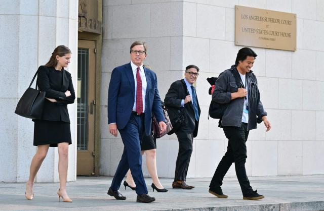 Plaintiffs' attorney Mark Lanier (2L) walks out the Los Angeles Superior Court as jury deliberations pause for the day in a trial over whether social media platforms were designed to be addictive to children, March 24, 2026. Jurors resume deliberations on March 24 in a landmark social media trial after signaling that they were having trouble agreeing when it comes to one of the two defendants, Meta and YouTube. "The jury has difficulty coming to a consensus regarding one defendant, do you have any advice on how to move forward?" the jurors told Judge Carolyn Kuhl, according to a note she read out loud. Kuhl responded by asking the jurors to continue their deliberations."If you are unable to reach a verdict, the case will have to be applied before another jury selected in the same manner and from the same community from which you were chosen, and add additional cost to everyone," she told the jurors. (Photo by Frederic J. Brown / AFP)