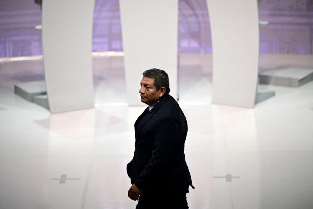 Peru's presidential candidate Walter Chirinos, for the Prin party, looks on ahead the second round of debates on tackling crime and corruption at the Lima Convention Center in Lima on March 24, 2026. Peru will hold presidential elections on April 12. (Photo by ERNESTO BENAVIDES / AFP)