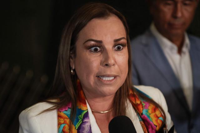 Peru's presidential candidate Fiorella Molinelli, for the Fuerza y Libertad party, gestures ahead of the second round of debates on tackling crime and corruption at the Lima Convention Center in Lima on March 24, 2026. Peru will hold presidential elections on April 12. (Photo by Connie FRANCE / AFP)