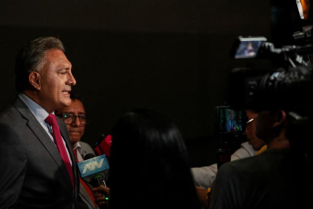 Peru's presidential candidate Carlos Jaico, for the Peru Moderno party, speaks to the press as he arrives at the Lima Convention Center ahead of the second round of debates on tackling crime and corruption in Lima on March 24, 2026. Peru will hold presidential elections on April 12. (Photo by Connie FRANCE / AFP)