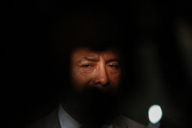 Peru's presidential candidate Carlos Jaico, for the Peru Moderno party, speaks to the press as he arrives at the Lima Convention Center ahead of the second round of debates on tackling crime and corruption in Lima on March 24, 2026. Peru will hold presidential elections on April 12. (Photo by Connie FRANCE / AFP)