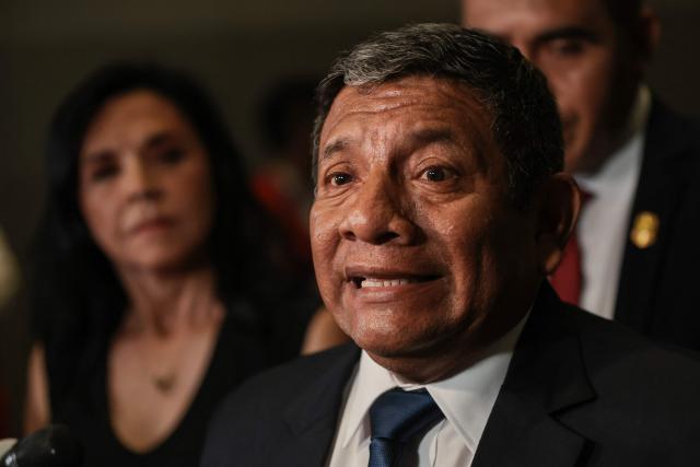 Peru's presidential candidate Walter Chirinos, for the Prin party, speaks to the press as he arrives at the Lima Convention Center ahead of the second round of debates on tackling crime and corruption in Lima on March 24, 2026. Peru will hold presidential elections on April 12. (Photo by Connie FRANCE / AFP)