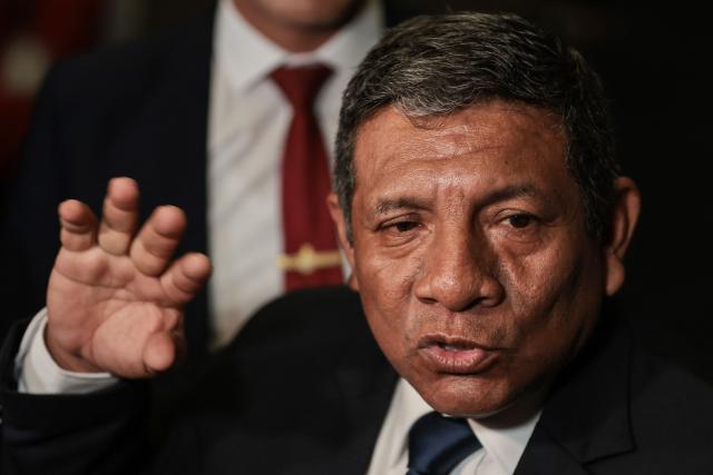 Peru's presidential candidate Walter Chirinos, for the Prin party, speaks to the press as he arrives at the Lima Convention Center ahead of the second round of debates on tackling crime and corruption in Lima on March 24, 2026. Peru will hold presidential elections on April 12. (Photo by Connie FRANCE / AFP)