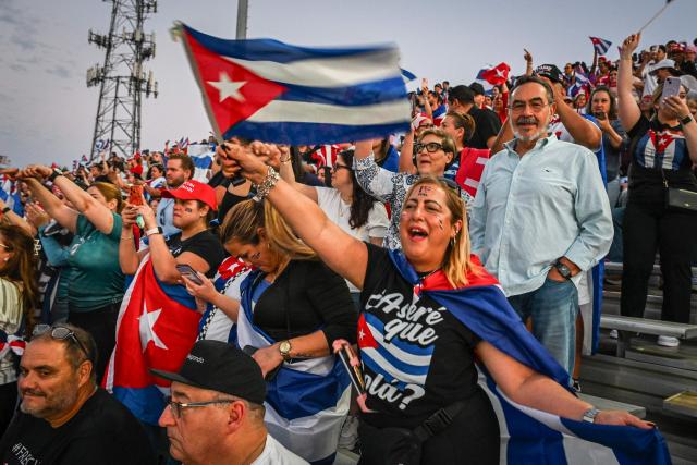 People wave flags and chant while participating in the "Cuba Libre" demonstration in the city of Hialeah, Florida, on March 24, 2026. (Photo by GIORGIO VIERA / AFP)