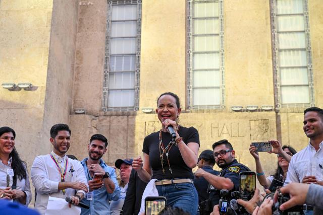 Venezuelan opposition leader Maria Corina Machado speaks during a meeting with the Venezuelan community in downtown Houston, Texas, on March 24, 2026, after attending the 2026 CERAWeek conference. Machado told AFP on March 24 that her country's formerly all-powerful socialist ideology has been fatally "wounded" by US President Donald Trump. The regime known as "Chavismo" that held Venezuela in its grip for a quarter of a century under Hugo Chavez and his successor Nicolas Maduro is "wounded irreparably and is being dismantled," Machado said. (Photo by RONALDO SCHEMIDT / AFP)