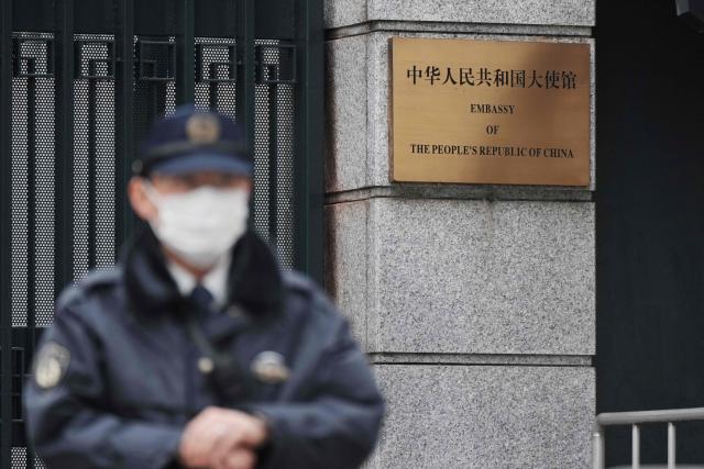 A policeman stands guard at an entrance to the Chinese embassy in Tokyo on March 25, 2026. A man was apprehended in Tokyo March 24 after he trespassed onto the grounds of the Chinese embassy in Tokyo. (Photo by Kazuhiro NOGI / AFP)