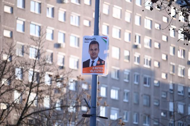 (FILES) An electoral campaign poster showing Hungary's ruling FIDESZ party spokesperson Balazs Nemeth is seen in one of Budapest's outer districts on February 27, 2026. Even if Hungary's nationalist premier Minister Viktor Orban loses next month's election, it does not mean relief for the country's embattled LGBTQ community, rights activists say. (Photo by Attila KISBENEDEK / AFP)