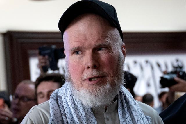 US citizen Dennis Coyle walks towards an Emirati private jet, upon his release by the Taliban, at the airport in Kabul on March 24, 2026. Afghanistan's Taliban government released a US national on March 24 who had been detained for more than a year, after a letter from his family requesting his freedom. (Photo by Wakil KOHSAR / AFP)