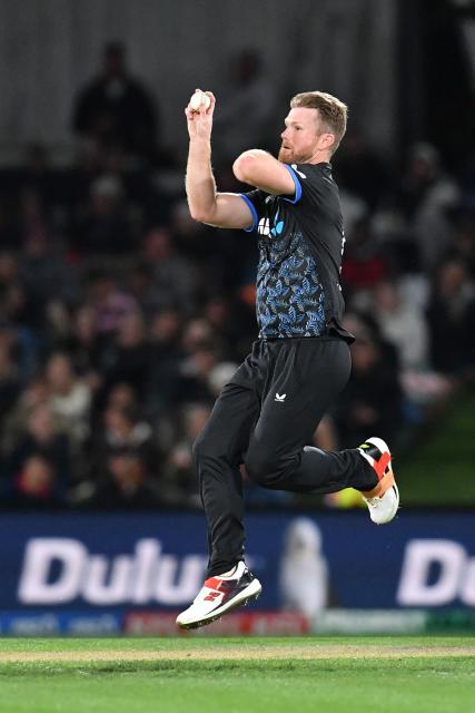 New Zealand's James Neesham bowls during the fifth Twenty20 international cricket match between New Zealand and South Africa at Hagley Oval in Christchurch on March 25, 2026. (Photo by Sanka Vidanagama / AFP)