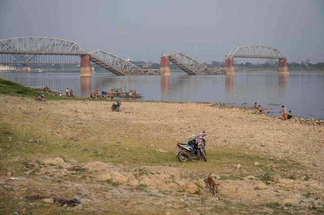 This photo taken on March 19, 2026 show the Irrawaddy River and the collapsed Ava Bridge, also known as the Iowa Bridge, in Sagaing after a magnitude 7.7 magnitude earthquake on March 28, 2025. The magnitude 7.7 magnitude earthquake on March 28, 2025 killed more than 3,700 people as it razed buildings in Myanmar's central belt, with devastation focused on the second-most-populous city of Mandalay. (Photo by Sai Aung MAIN / AFP)