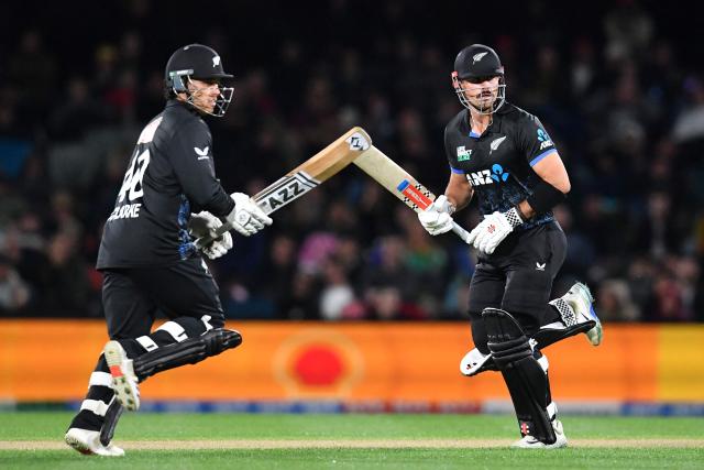New Zealand's Tim Robinson (R) and Katene Clarke run between the wickets during the fifth Twenty20 international cricket match between New Zealand and South Africa at Hagley Oval in Christchurch on March 25, 2026. (Photo by Sanka Vidanagama / AFP)