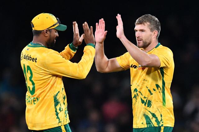 South Africa's Wiaan Mulder (R) celebrates with teammate Prenelan Subrayen after taking the wicket of New Zealand's Katene Clarke during the fifth Twenty20 international cricket match between New Zealand and South Africa at Hagley Oval in Christchurch on March 25, 2026. (Photo by Sanka Vidanagama / AFP)