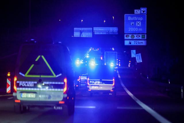 The truck carrying a Castor container for high-level radioactive waste is escorted by police vehicles as it drives on the A3 motorway in Bottrop, western Germany, on March 25, 2026. (Photo by Christoph Reichwein / dpa pool / AFP)