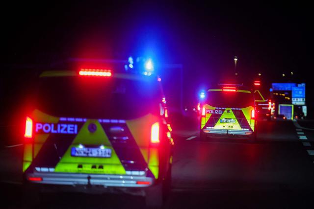 The truck carrying a Castor container for high-level radioactive waste is escorted by police vehicles as it drives on the A3 motorway in Bottrop, western Germany, on March 25, 2026. (Photo by Christoph Reichwein / dpa pool / AFP)